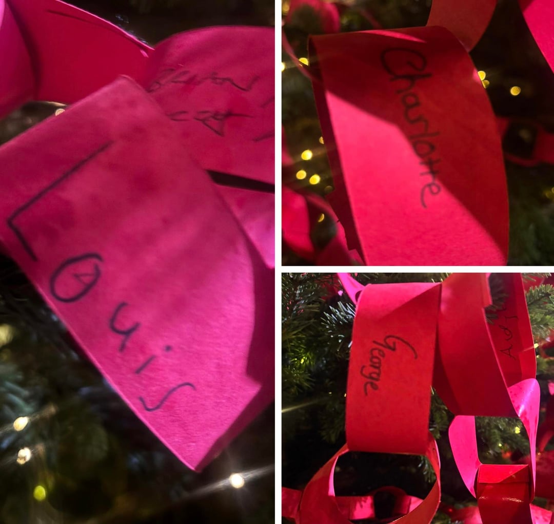 The Wales children wrote their names on links of red paper and added it to the ‘connection tree’ outside Westminster Abbey tonight to symbolise togetherness