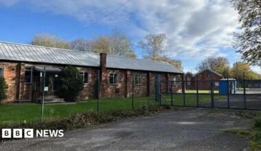 An exterior view of Crowborough Training Camp form outside the perimeter fence and locked gates.