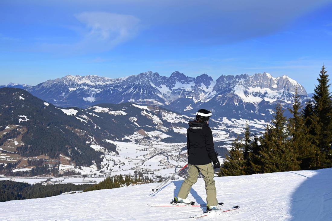 Ein Skifahrer steht auf einer Piste mit Kunstschnee. Die gegenueberligenden Haenge sind gruen mit wenig Schnee. (Archivfoto)