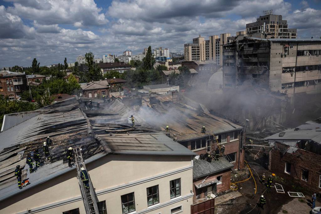 Firefighters responding to a fire on a rooftop after a Russian strike in Kharkiv, Ukraine, July 24, 2025. (David Guttenfelder/The New York Times)