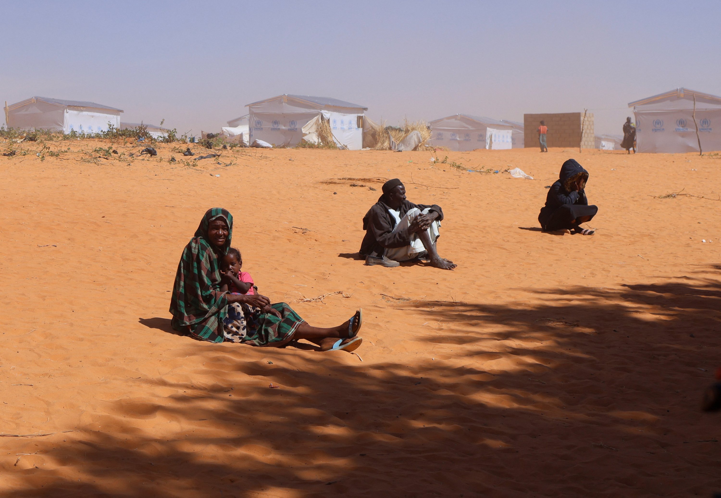 Sudanese refugees from Darfur sit on the ground during a sandstorm at the Touloum refugee camp, amid ongoing conflict in their country, Iriba in Wadi Fira province, eastern Chad, Nov. 30, 2025. (Reuters Photo)