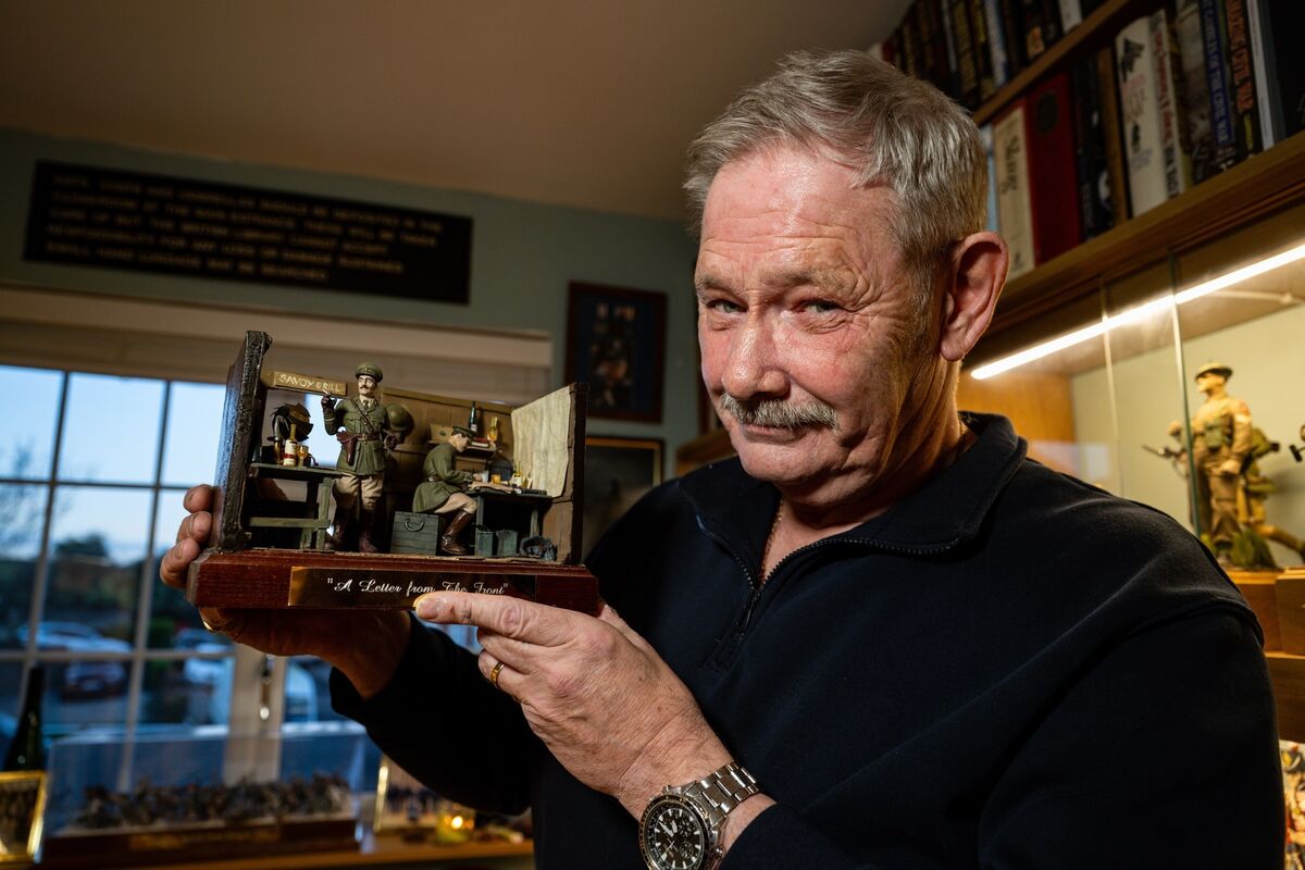 David Edwards stands amid his vast military collection in his Youghal home, holding one of his characterful Blackadder-inspired figures. Picture: Chani Anderson