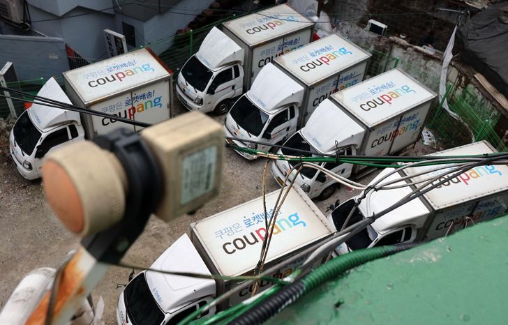 Coupang's delivery trucks are parked at a parking lot in Seoul, Sunday. Yonhap