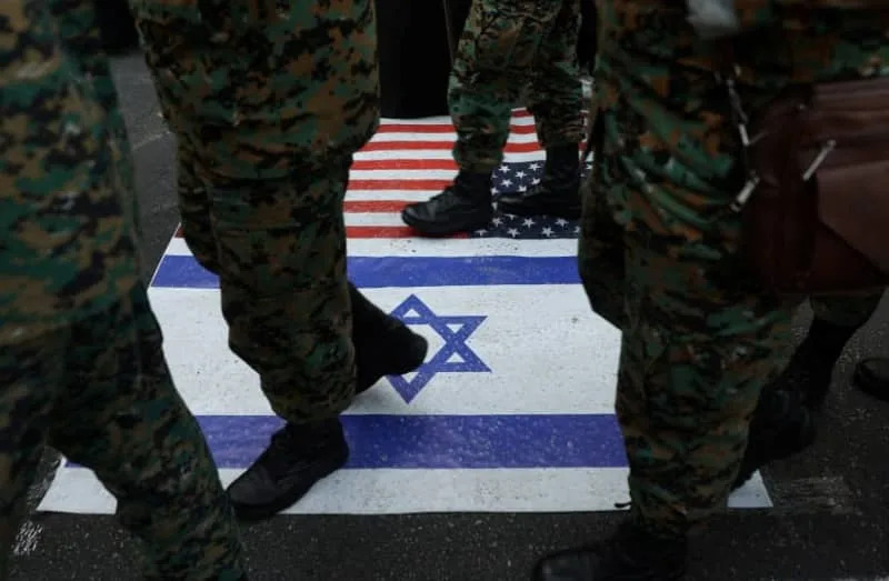 Members of the IRGC step on US and Israeli flags during the 46th anniversary of the U.S. expulsion from Iran, in Tehran, November 4, 2025. (credit: MAJID ASGARIPOUR/WANA (WEST ASIA NEWS AGENCY) VIA REUTERS)