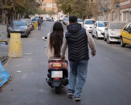 A woman riding  a motorcycle on the road in Iran
