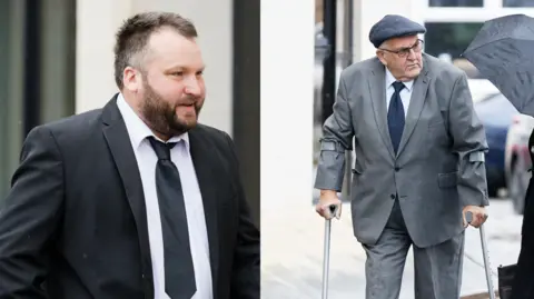 Athena Pictures Agency A man is walking while wearing a black suit jacket, a black tie and a white shirt and has a beard. Another man is wearing a grey suit jacket, dark blue tie and a white shirt, glasses and a flat cap. He is walking using two crutches.