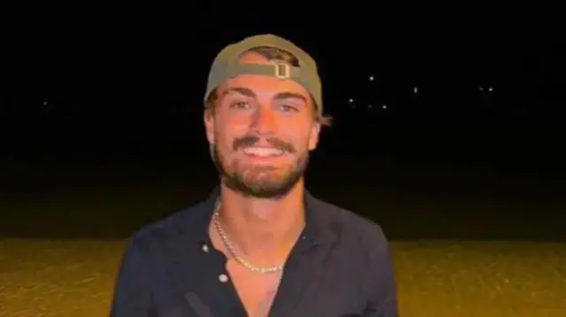 A young man smiles in a picture