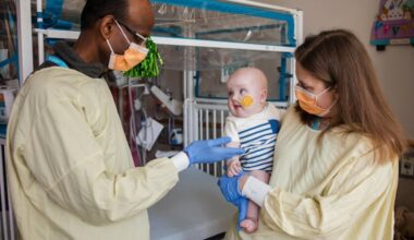 Kiran Musunuru, the Barry J. Gertz Professor for Translational Research in Penn’s Perelman School of Medicine (left), and Rebecca Ahrens-Nicklas, director of the Gene Therapy for Inherited Metabolic Disorders Frontier Program (GTIMD) at Children’s Hospital of Philadelphia, with KJ Muldoon at Children’s. KJ's rare genetic disorder has been treated with CRISPR gene editing therapy by a team at the two facilities.