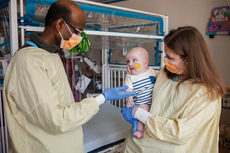 Kiran Musunuru, the Barry J. Gertz Professor for Translational Research in Penn’s Perelman School of Medicine (left), and Rebecca Ahrens-Nicklas, director of the Gene Therapy for Inherited Metabolic Disorders Frontier Program (GTIMD) at Children’s Hospital of Philadelphia, with KJ Muldoon at Children’s. KJ's rare genetic disorder has been treated with CRISPR gene editing therapy by a team at the two facilities.
