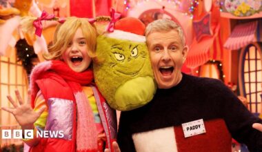 Cat Deeley and Patrick Kielty pose in front of a yellow background.