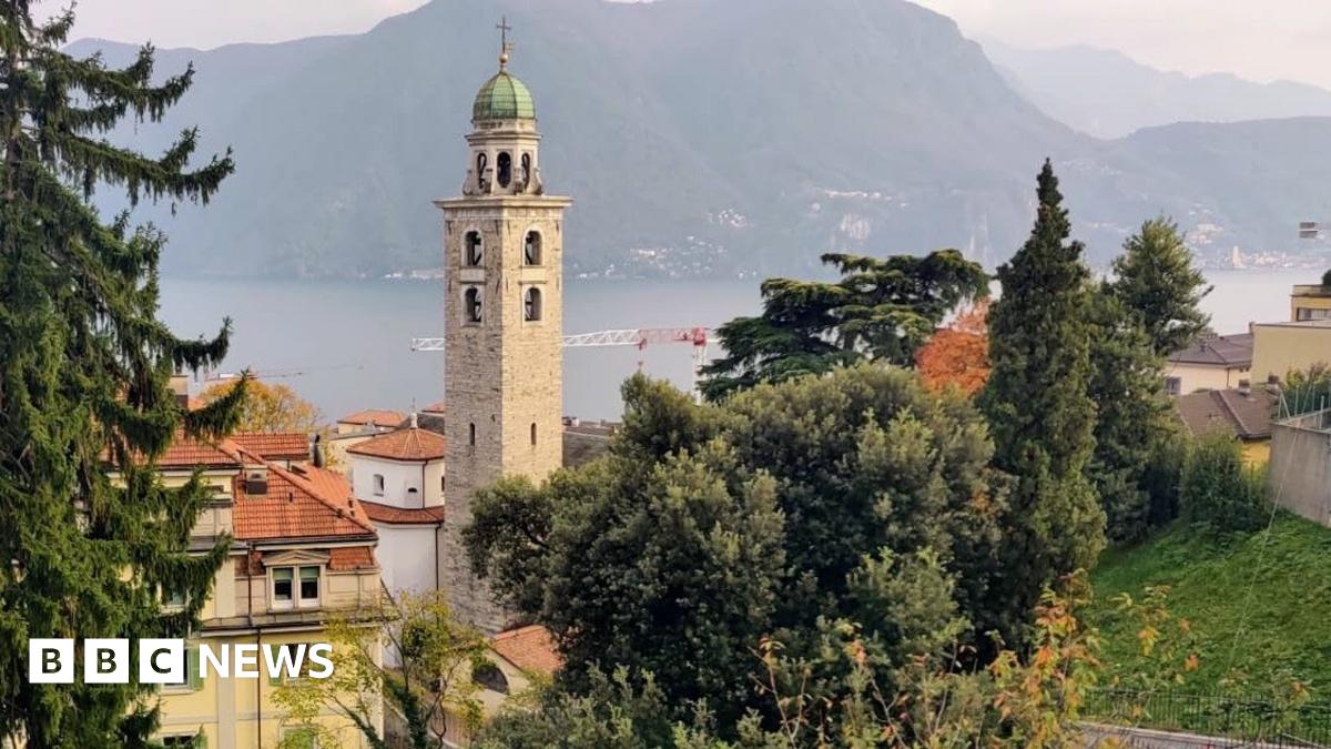 People walking in a central square in the Swiss city of Lugano