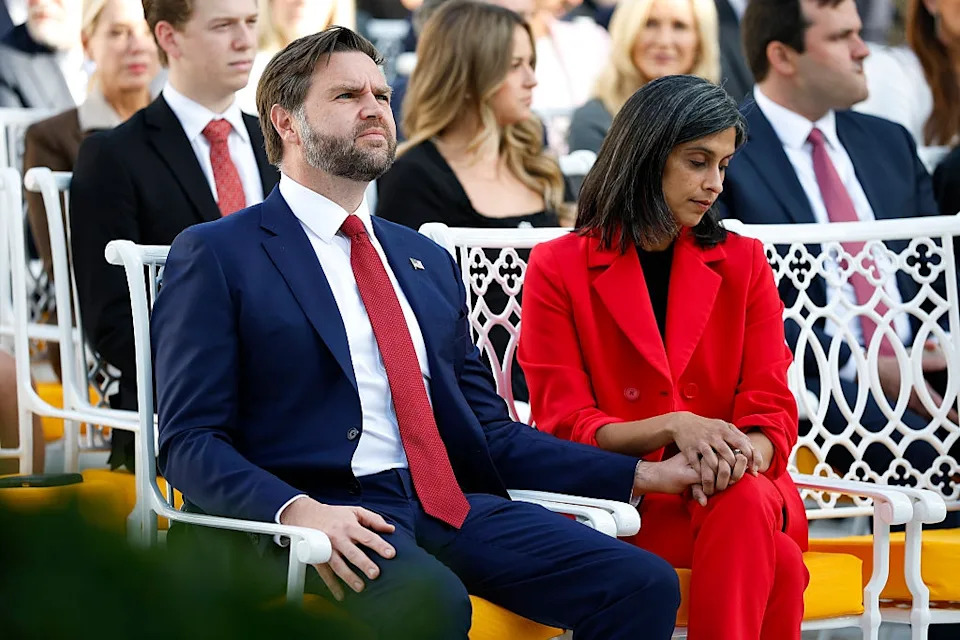 jd vance and usha vance holding hands in an outdoor audience setting