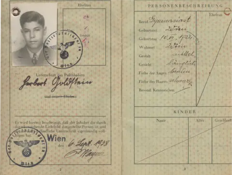Herbert King A page inside Herbert King's passport from 1938 including a black and white photograph of him with two Nazi stamps on it which include a swastika