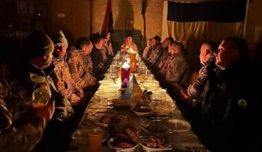 Soldiers from the Ukrainian Army, gathered at a table for their Christmas Eve dinner.