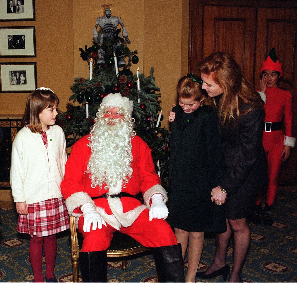 Princesses Beatrice and Eugenie each side of Father Christmas in 1999