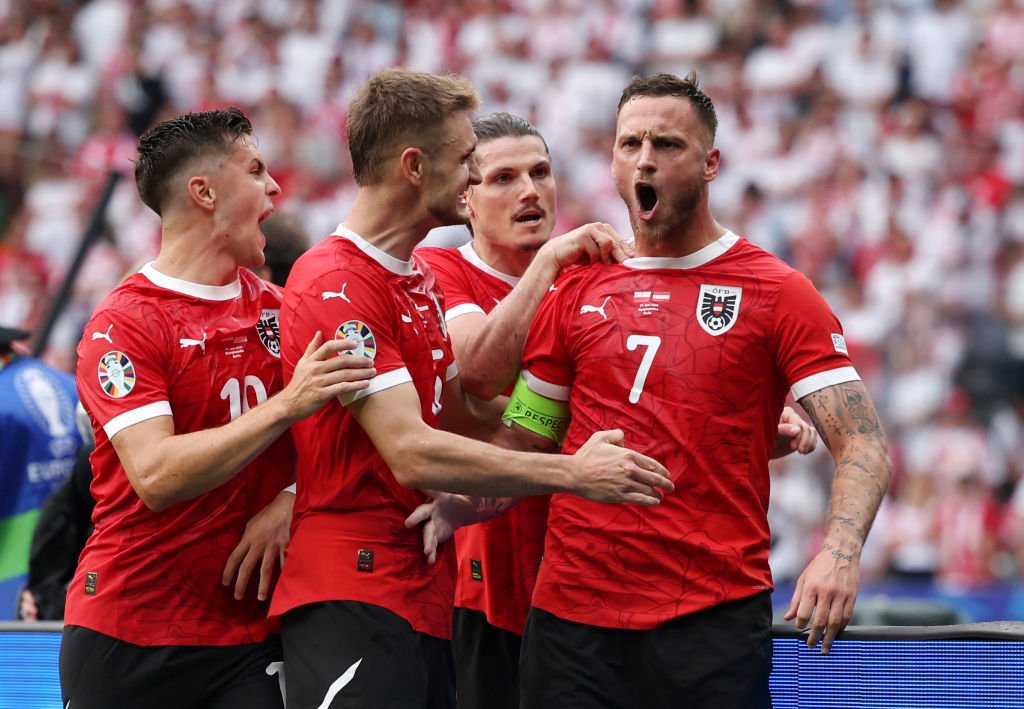 Marko Arnautovic of Austria celebrates scoring his team's third goal from a penalty kick with teammates during the UEFA EURO 2024 group stage match between Poland and Austria at Olympiastadion on June 21, 2024 in Berlin, Germany.
