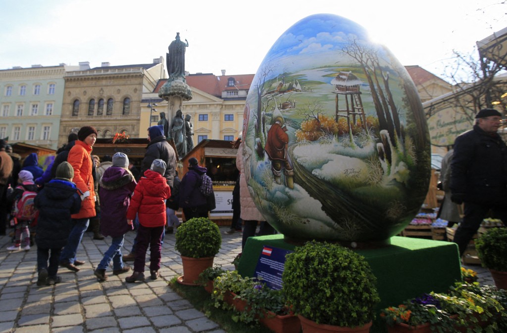 People look at a giant Easter egg in Vienna