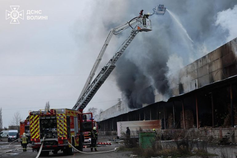 This handout photograph taken and released by the State Emergency Service of Ukraine on December 6, 2025, shows firefighters extinguishing a fire at a site of an air attack in Volyn Region, amid the Russian invasion of Ukraine. (Photo by Handout / STATE EMERGENSY SERVICE OF UKRAINE / AFP) / RESTRICTED TO EDITORIAL USE - MANDATORY CREDIT "AFP PHOTO / STATE EMERGENCY SERVICE OF UKRAINE" - NO MARKETING NO ADVERTISING CAMPAIGNS - DISTRIBUTED AS A SERVICE TO CLIENTS