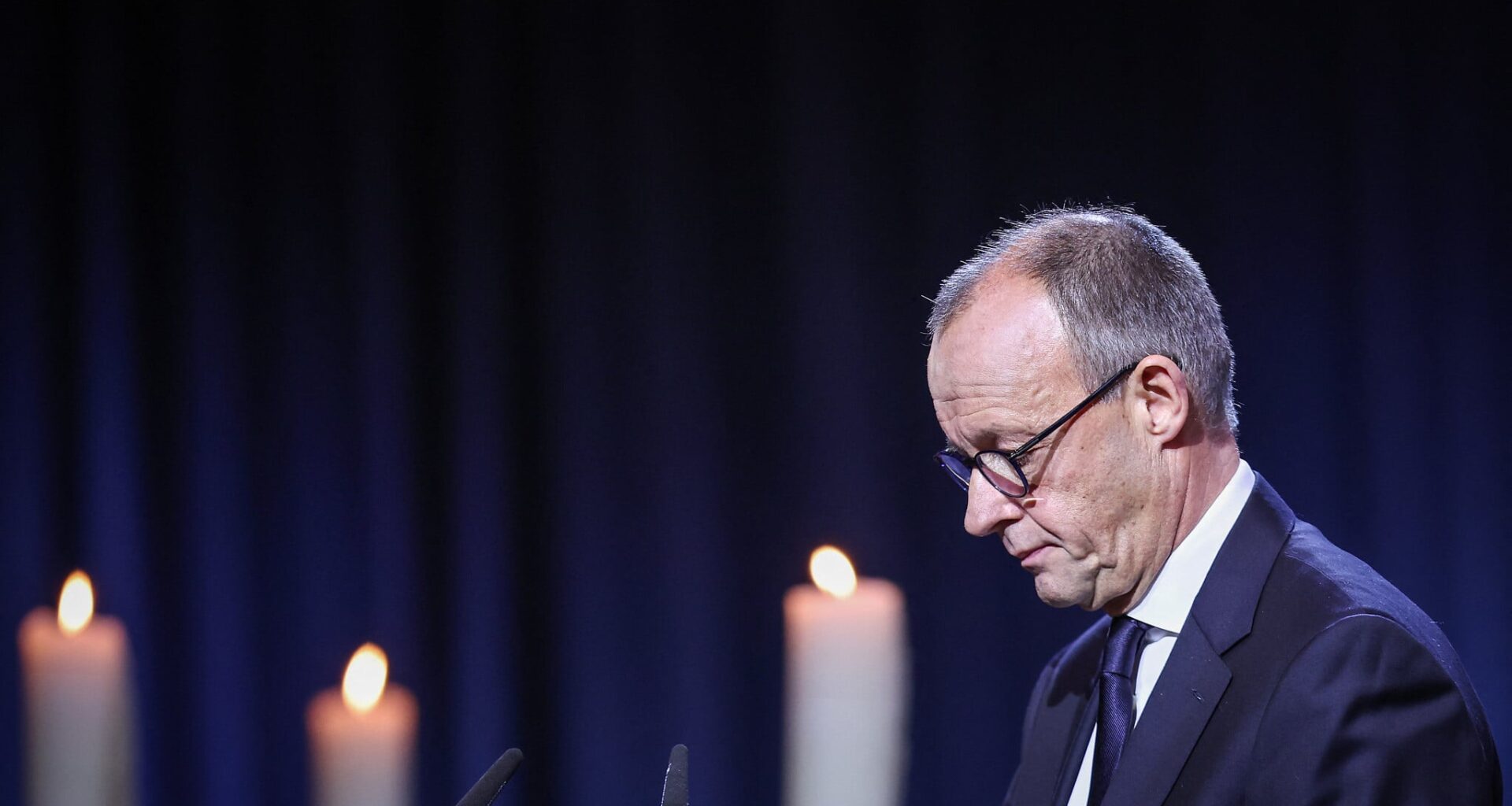 German chancellor urges 'peaceful coexistence,' a year after deadly market attack