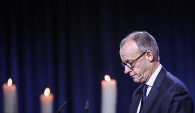 German chancellor urges 'peaceful coexistence,' a year after deadly market attack