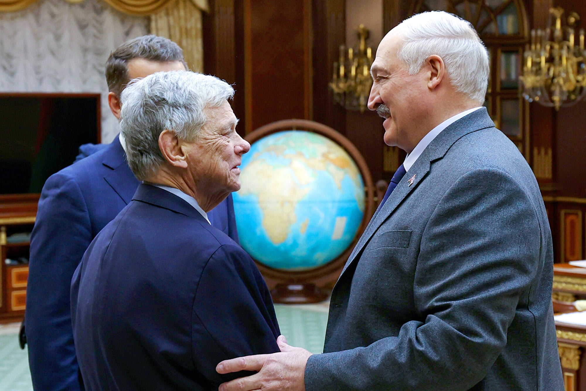 President Alexander Lukashenko, right, and US presidential envoy John Coale shake hands