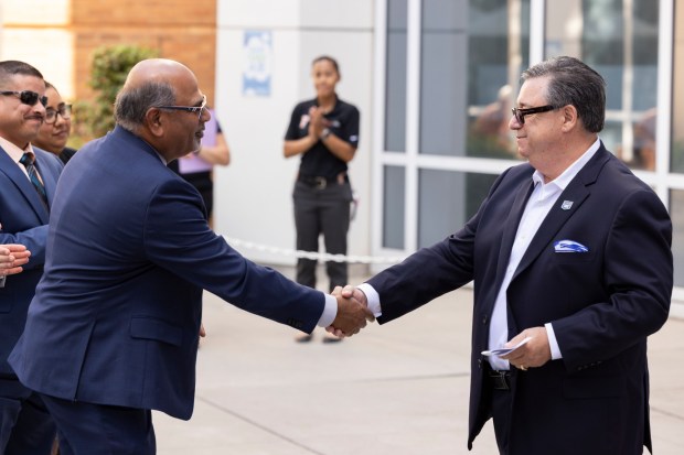 Sri Sundaram, dean of the College of Business and Economics, left, thanks donor Jerry Conrey for supporting students and entrepreneurialeducation at CSUF. (Photo courtesy of Cal State Fullerton)