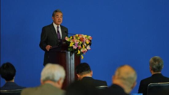 China's Foreign Minister Wang Yi delivers the opening speech on stage for the annual symposium on the international situation and China's foreign relations held by China Institute of International Studies at the Diaoyutai State Guesthouse, in Beijing, on Tuesday (AP)