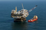 FILE - A rig and supply vessel are viewed in the Gulf of Mexico off the cost of Louisiana,...