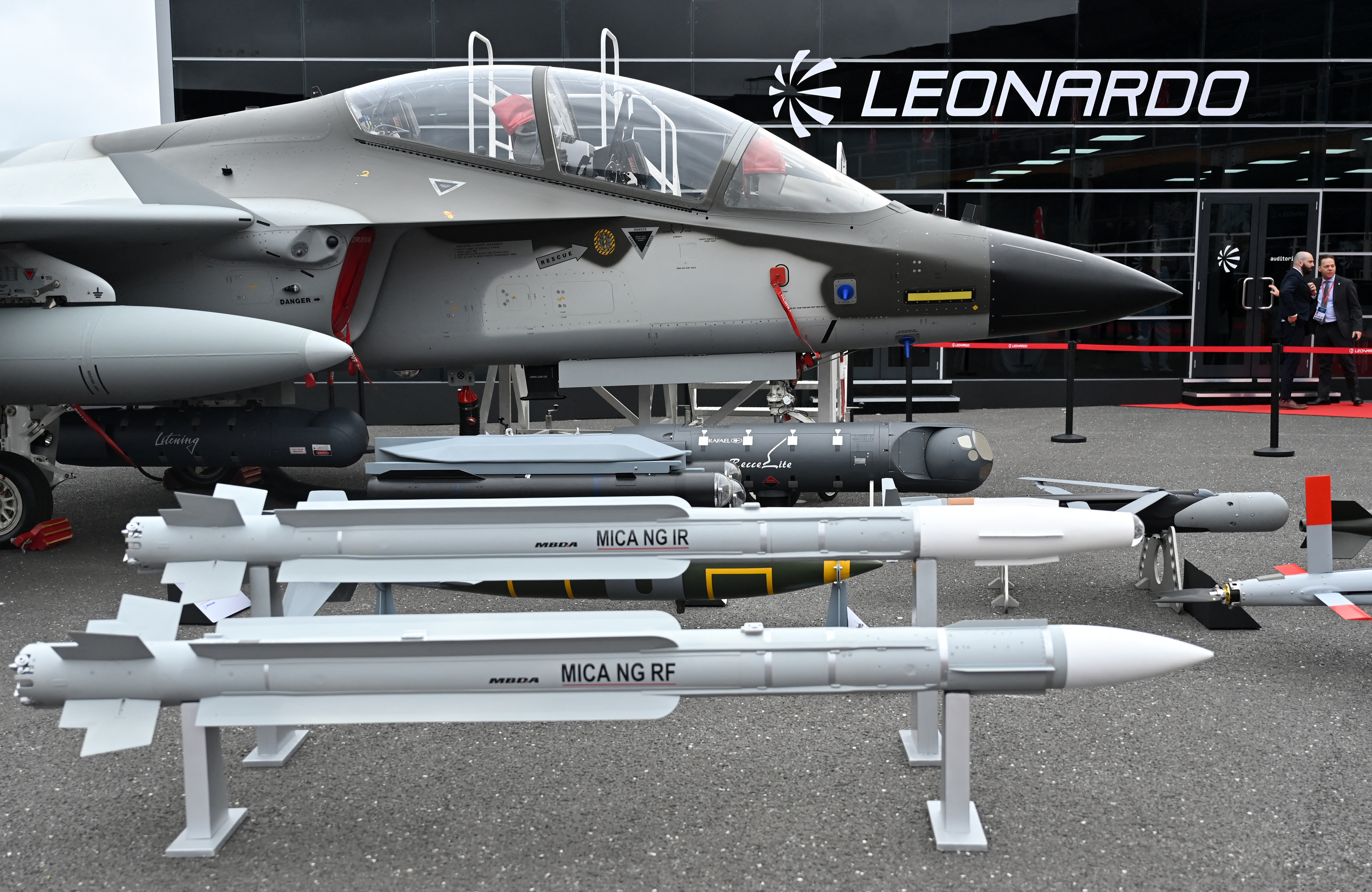A Leonardo Aermacchi M-346 FA Attack Fighter Jet is pictured with MBDA's MICA NG IR (C), and MICA NG IR air-to-air missiles, outside the Leonardo stand on the second day of the Farnborough International Airshow 2024, south west of London, on July 23, 2024. (Photo by JUSTIN TALLIS / AFP) (Photo by JUSTIN TALLIS/AFP via Getty Images)