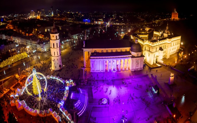 Vilnius, Lithuania - 30th november, 2024: aerial panorama view cathedral square and Xmas market visitors sightseeing beautiful Xmas tree in city Vilnius - the european capital of Christmas 2025