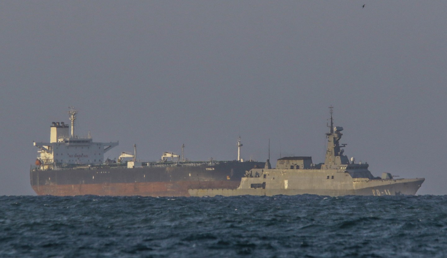 A Venezuelan navy patrol boat escorts Panamanian flagged crude oil tanker Yoselin near the El Palito refinery in Puerto Cabello, Venezuela on Nov. 11. Venezuela on Tuesday announced what it called a major, nationwide military deployment to counter the US naval presence off its coast. 
