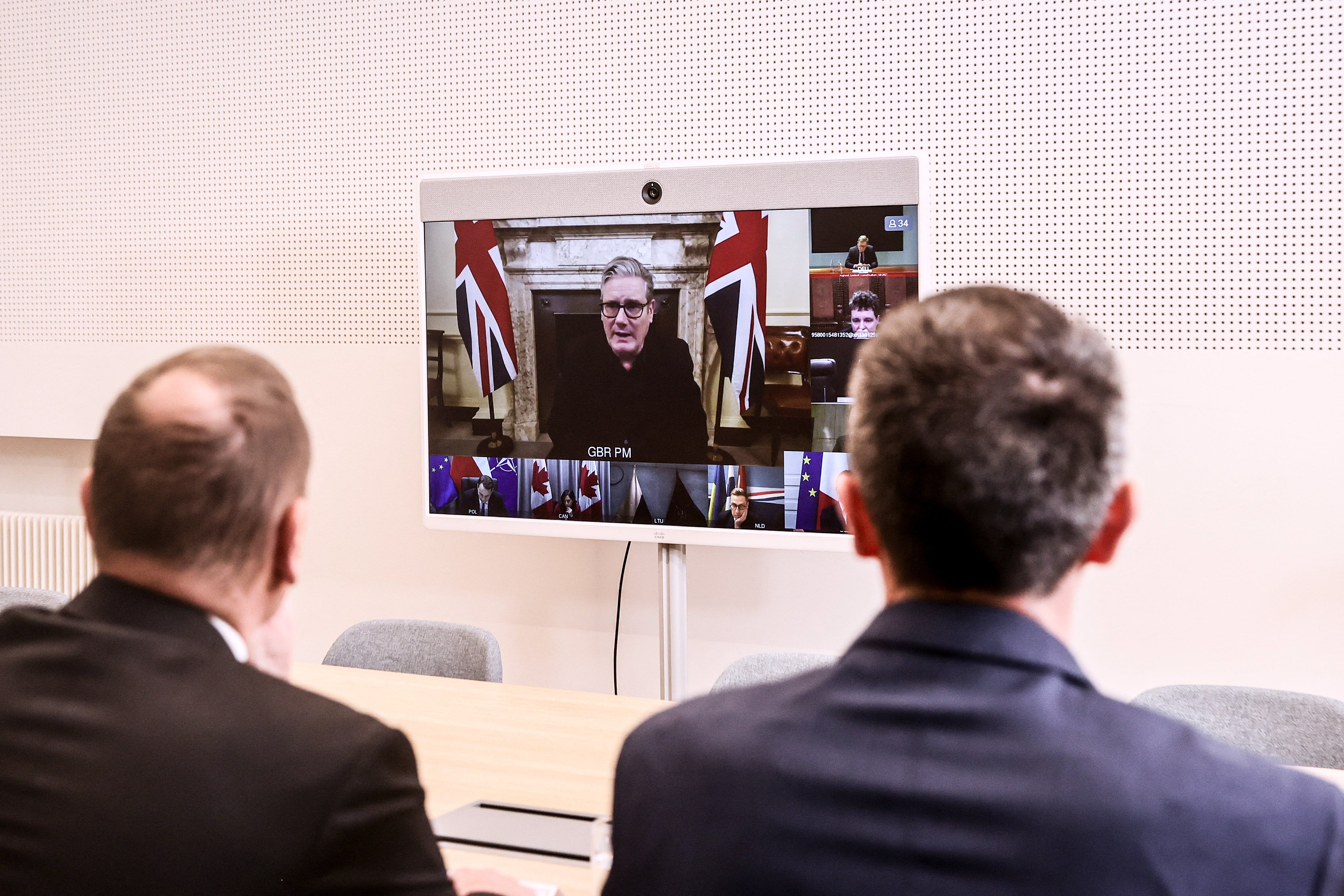 British prime minister Keir Starmer appears on screen at the Elysee Palace during a video conference Coalition of the Willing meeting, in Paris, on 11 December 2025