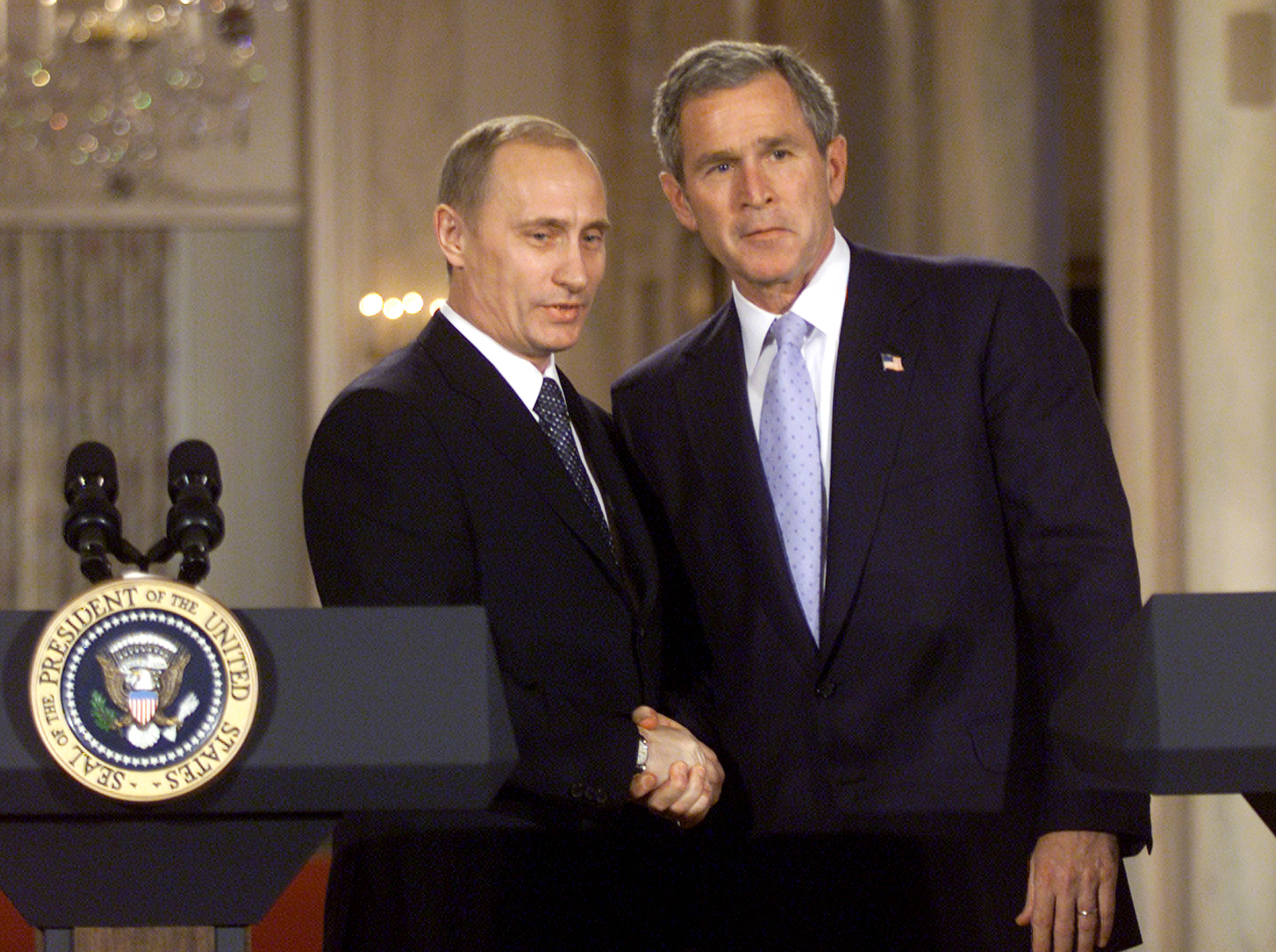 U.S. President George W. Bush (R) and Russian President Vladimir Putin shake hands after speaking with the media in the East Room of the White House November 13, 2001 in Washington, DC.
