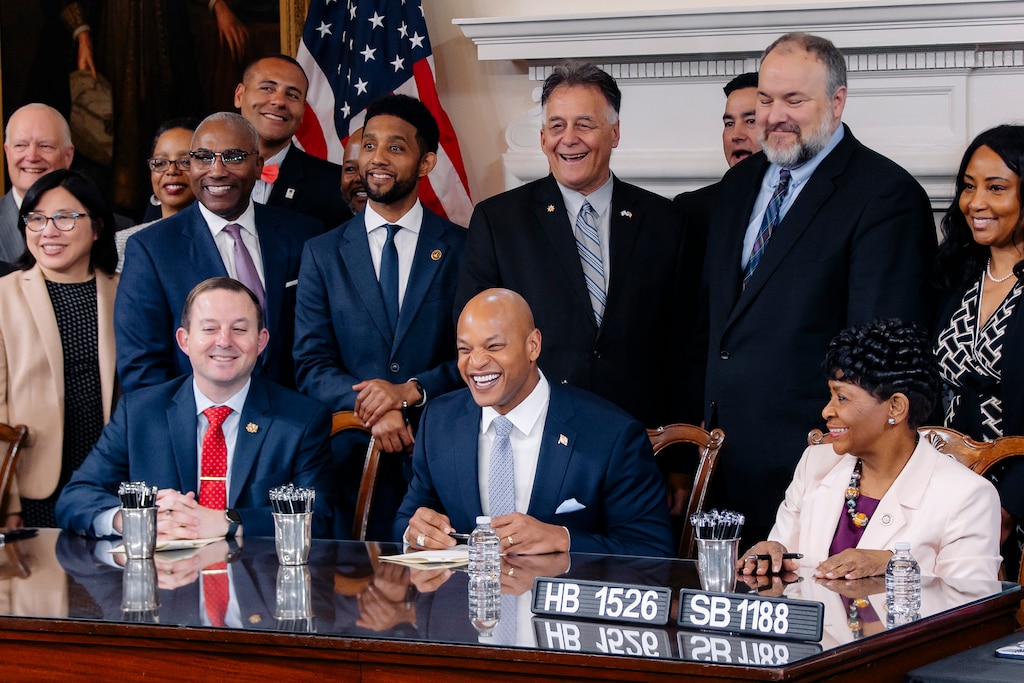 Seated, from left, Senate President Bill Ferguson, Gov. Wes Moore and House of Delegates Speaker Adrienne A. Jones laugh with proponents of the PORT Act at a bill signing ceremony following the conclusion of the 2024 Maryland General Assembly at the Maryland State House on Tuesday, April 9, in Annapolis, MD.