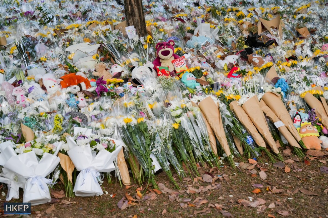 Mourners paid their respects to the dead outside Wang Fuk Court in Tai Po.