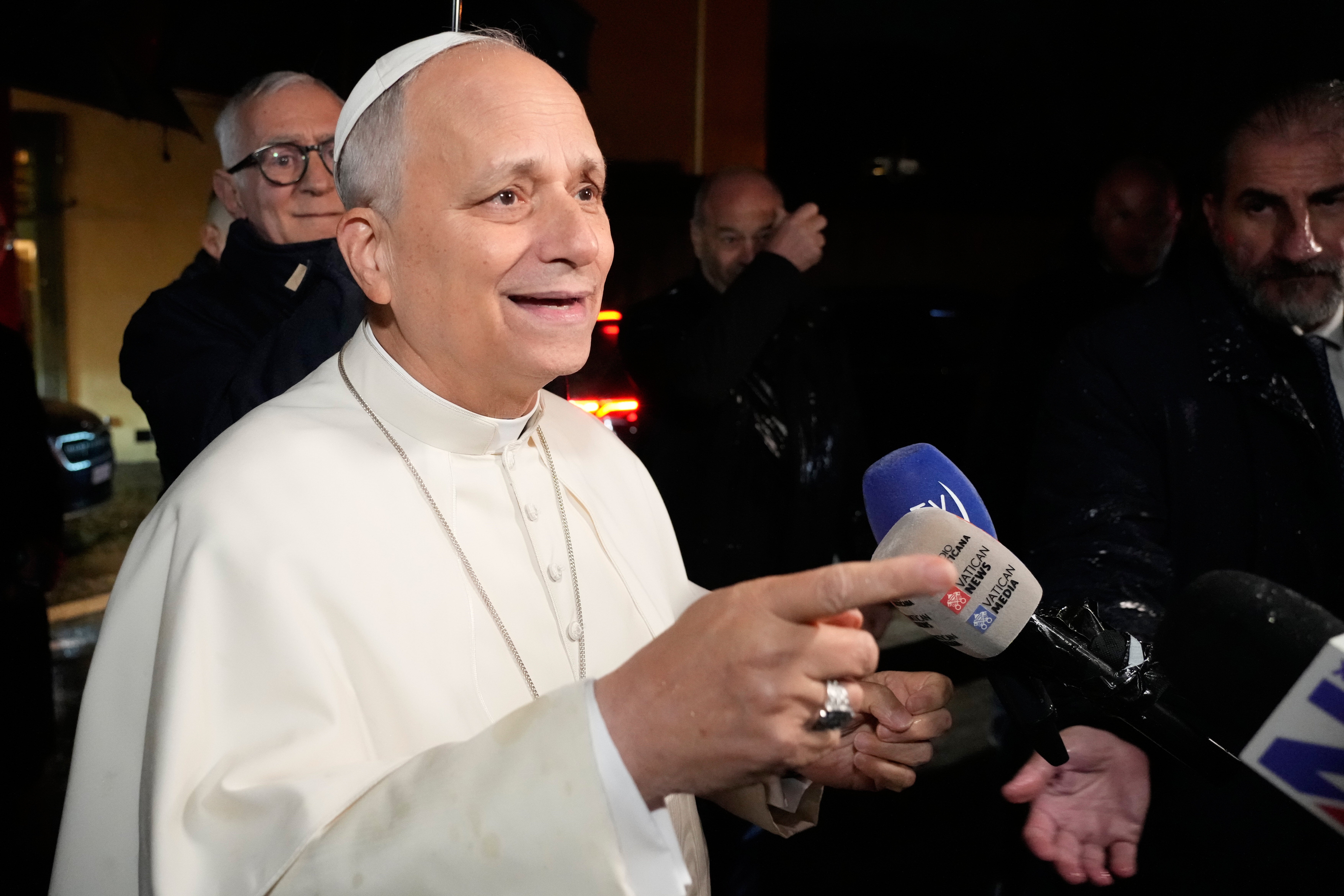 Pope Leo XIV talks to journalists as he leaves the Castel Gandolfo residence to head to the Vatican