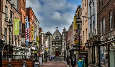 A street with shops and a church.