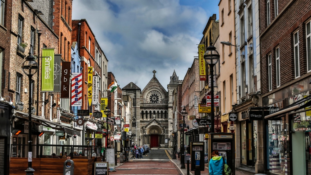 A street with shops and a church.