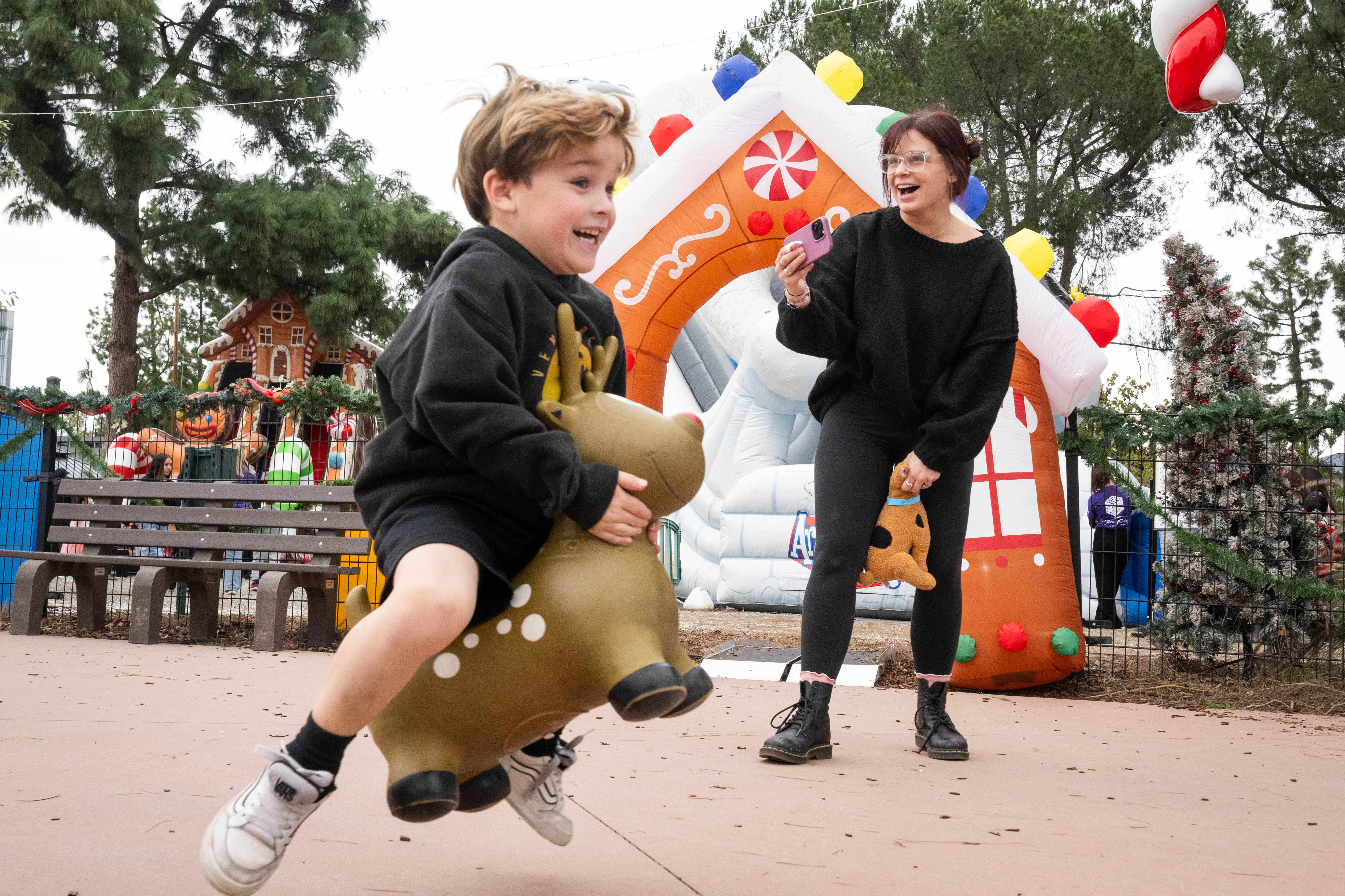 Children race on bouncy reindeer during the Discovery Cube’s winter...