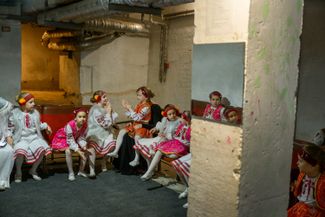 Children wait in the basement of a youth cultural center ahead of a St. Nicholas Day performance in Kharkiv on December 6, 2025. The holiday has grown in popularity since the start of the full-scale war, as volunteers and local officials work to give children moments of normalcy amid constant air raid alerts.