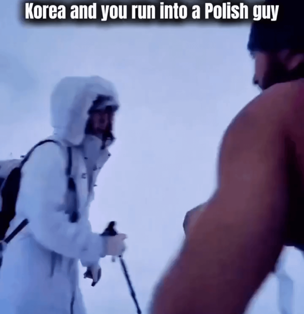 Polish man walks up a snowy mountain without excessive clothing.