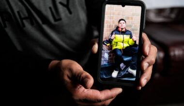 Lenin Suarez holds a photograph of his brother Victor, at his home on Dec. 10 in Seaford, Del.