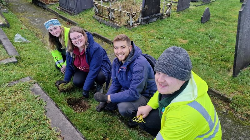 Refugees join biodiversity effort at Gwynedd churchyard.jpg
