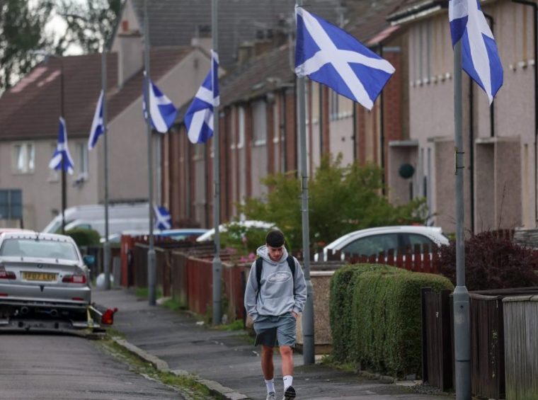FALKIRK, SCOTLAND - SEPTEMBER 05: Saltire flags appear in Scottish towns and Cities following a social media campaign by a group connected with asylum seeker demonstrations on September 05, 2025 in Falkirk, Scotland. After a right-wing social media campaign in England saw the St George Cross and Union Flag hoisted from lampposts in support of anti-migrant sentiment, Scotland has seen similar activity with Saltires appearing on the streets. First Minister John Swinney has said that the Saltire is a 