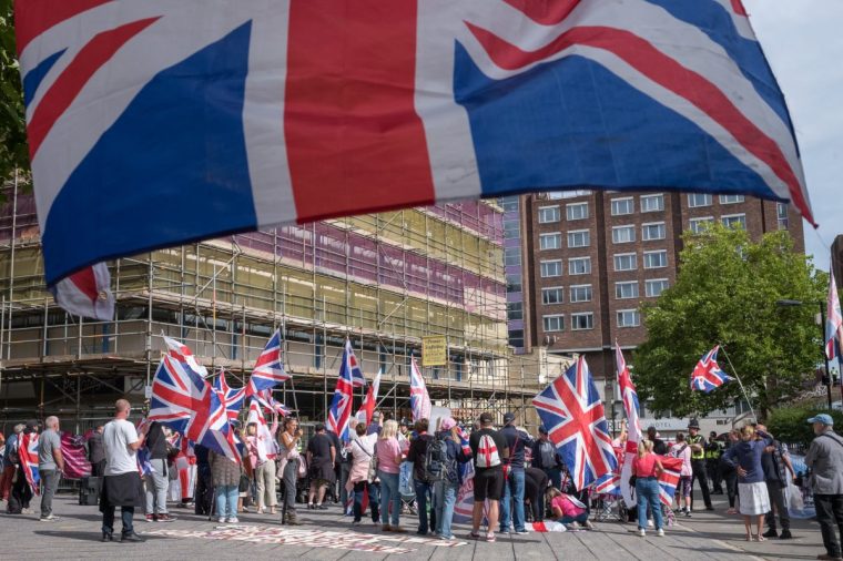 NEWCASTLE UPON TYNE, ENGLAND - SEPTEMBER 06: Demonstrators gather during an anti-immigration protest outside the New Bridge Hotel in Newcastle on September 06, 2025 in Newcastle upon Tyne, England. Far right protests have been taking place across the country over the summer weeks outside hotels housing migrants, following an accusation of sexual assault against an asylum seeker staying at the Bell Hotel in Epping. (Photo by Ian Forsyth/Getty Images)