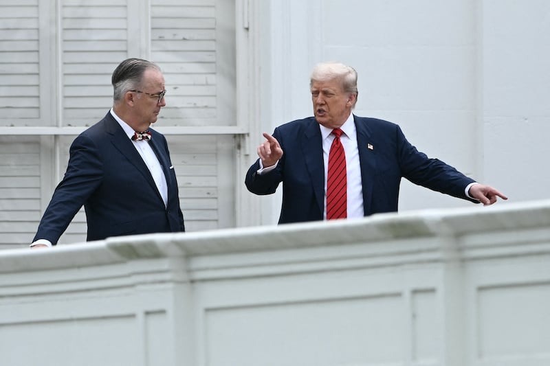 US President Donald Trump, alongside architect James C. McCrery, surveys the grounds of the White House from the roof, in Washington, DC, on August 5, 2025.