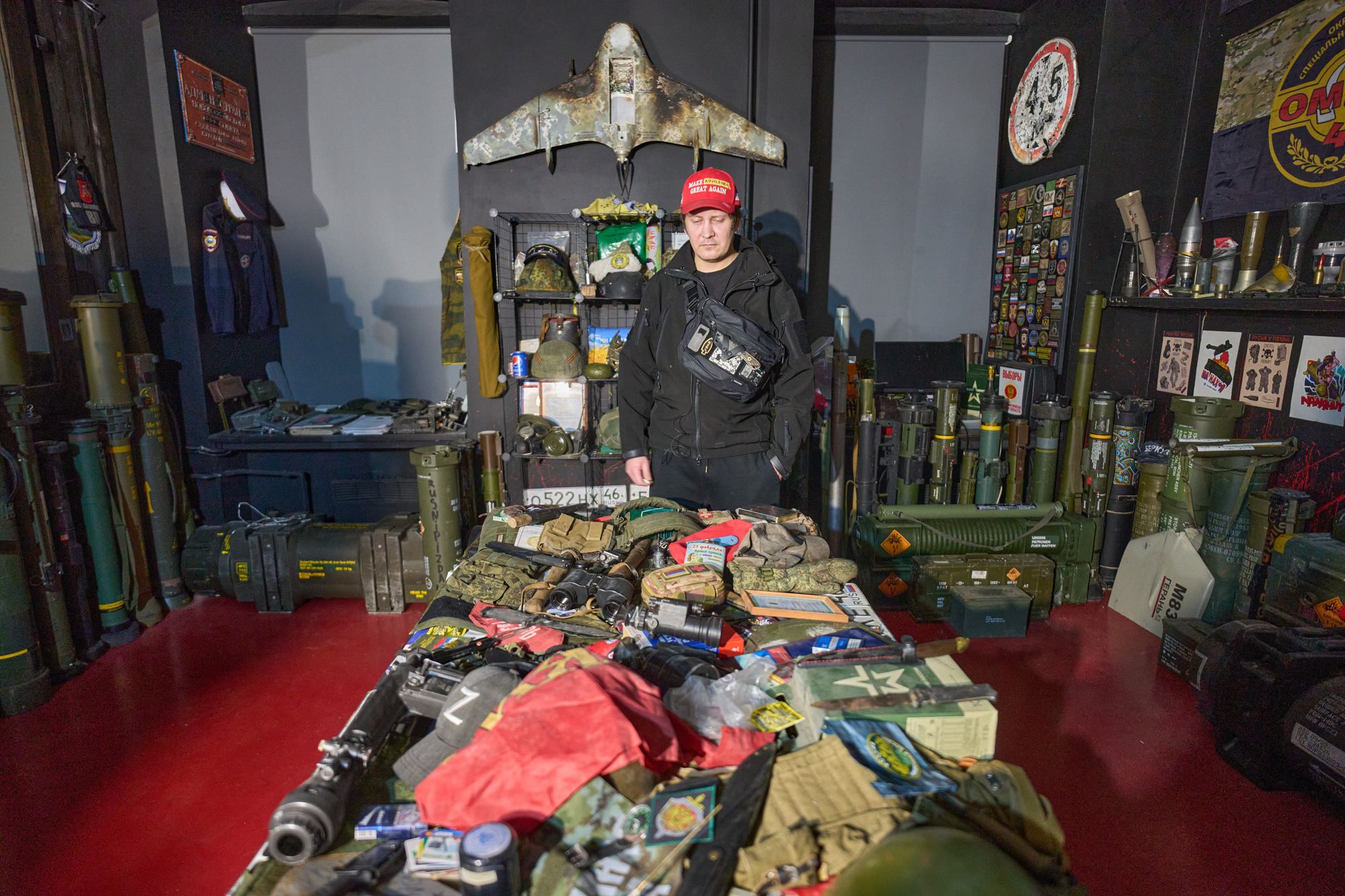 Ukrainian street artist Maxim Kilderov stands with a collection of battlefield artifacts documenting Russia's invasion of Ukraine in his private museum in Kyiv