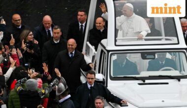 Pope Leo XIV waves to faithfull as he arrives aboard the popemobile ahead of addressing the Urbi et Orbi message and blessing to the city and the world as part of Christmas celebrations, at St Peter's square in the Vatican on December 25, 2025. (Photo by Andreas SOLARO / AFP)