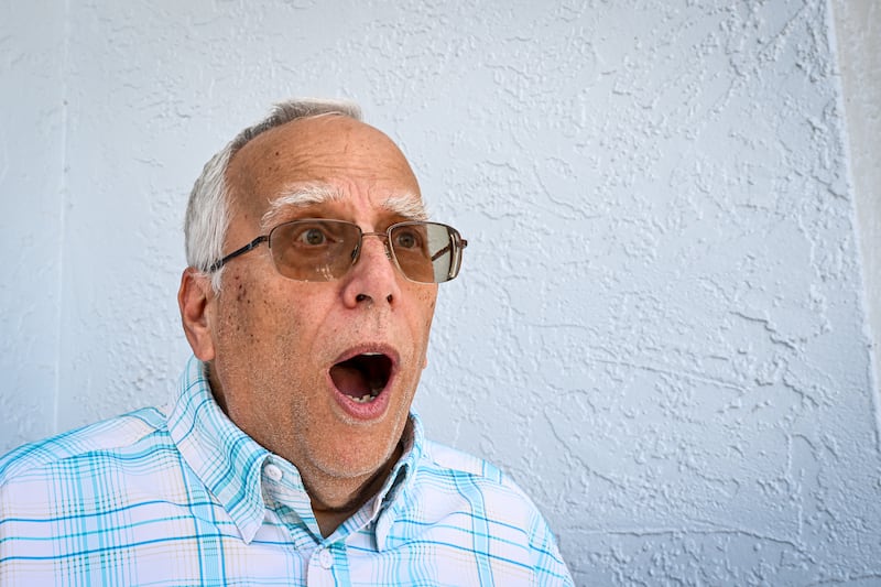 Louis Prevost, brother of newly elected Pope Leo XIV, Robert Prevost, reenacts his reaction after he saw his brother on television, during an AFP interview outside his home in Port Charlotte, Florida, on May 9, 2025.