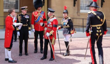 King Charles talks to Prince William while Princess Anne looks on